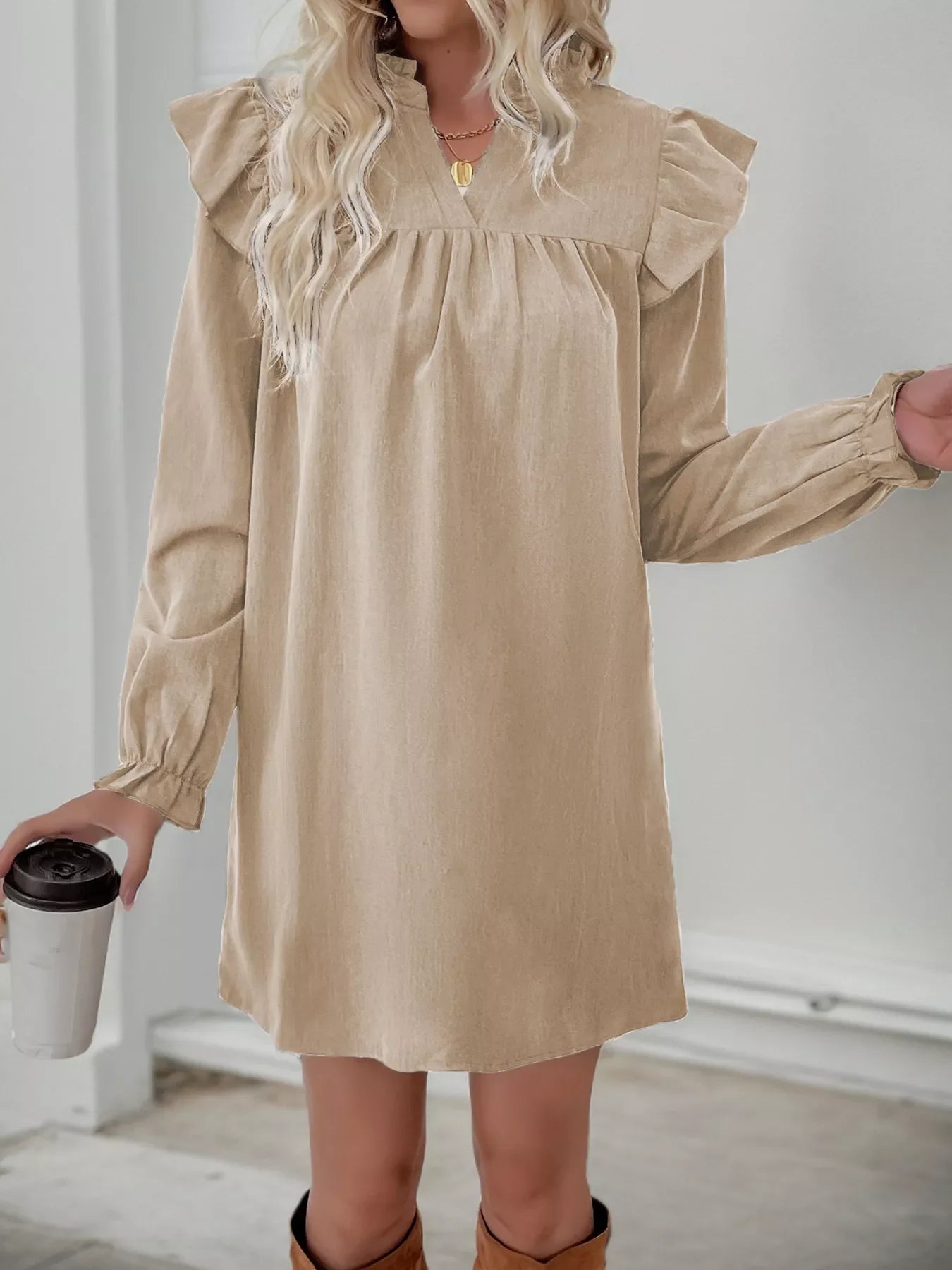 Apricot ruffled notched sleeve dress with cinched cuffs and a V-neckline.