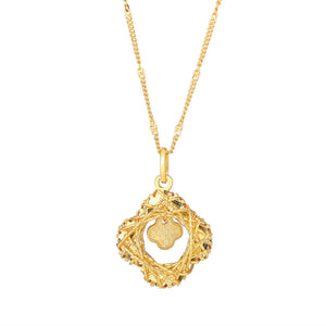 Gold clover pendant necklace with intricate woven frame.