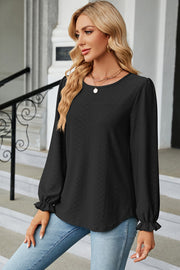Black textured puff sleeve blouse with ruffle cuffs and crew neck