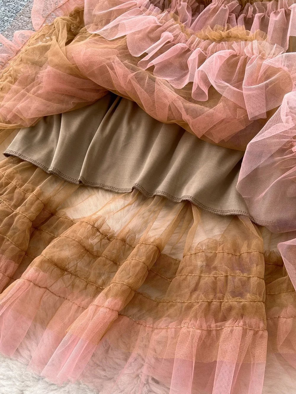Tiered ruffle tulle skirt in brown and pink with a satin lining.