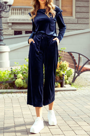 Indigo velvet culotte set with flutter sleeves and drawstring waist, styled with white sneakers.