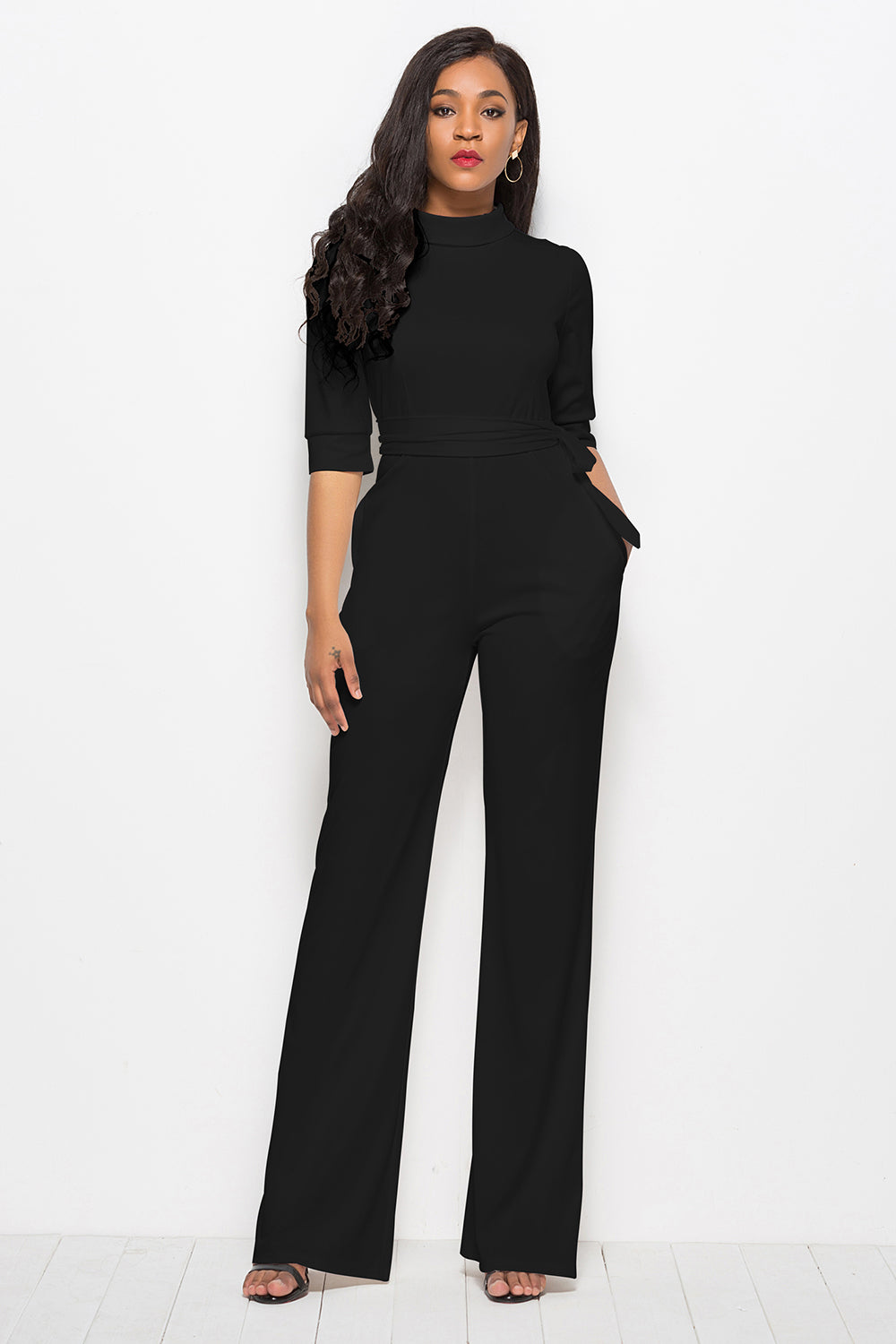Black high-neck belted palazzo jumpsuit with 3/4 sleeves and wide legs.