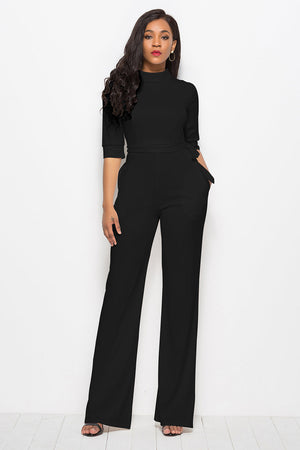Black high-neck belted palazzo jumpsuit with 3/4 sleeves and wide legs.