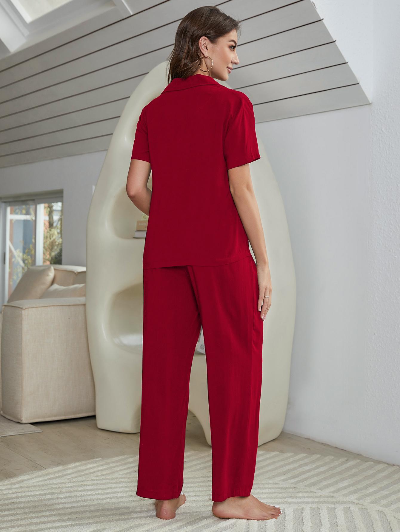 Red silk-blend pajama set with short sleeve collared shirt and wide-leg pants.