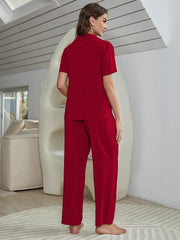 Red silk-blend pajama set with short sleeve collared shirt and wide-leg pants.