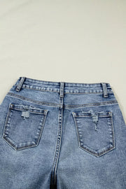 Cuffed mid-rise relaxed fit jeans in light wash denim with distressed back pockets.