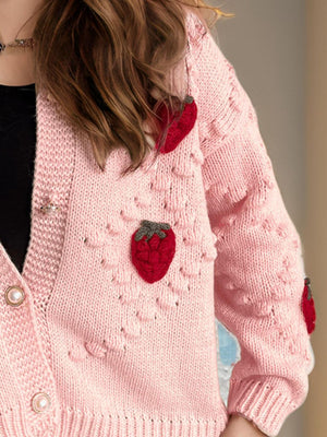 Pink knit cardigan with strawberry patchwork detail and pearl buttons