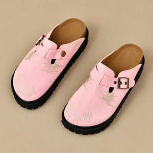 Pink embroidered denim platform clogs with buckle detail