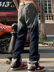 Two-tone distressed loose fit jeans with heavy fraying at the hems.