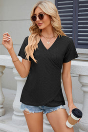 Black eyelet wrap v-neck top with short sleeves and a textured pattern.
