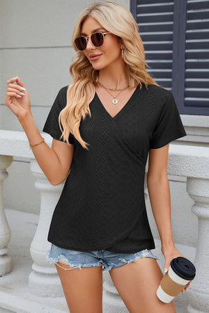 Black eyelet wrap v-neck top with short sleeves and a textured pattern.