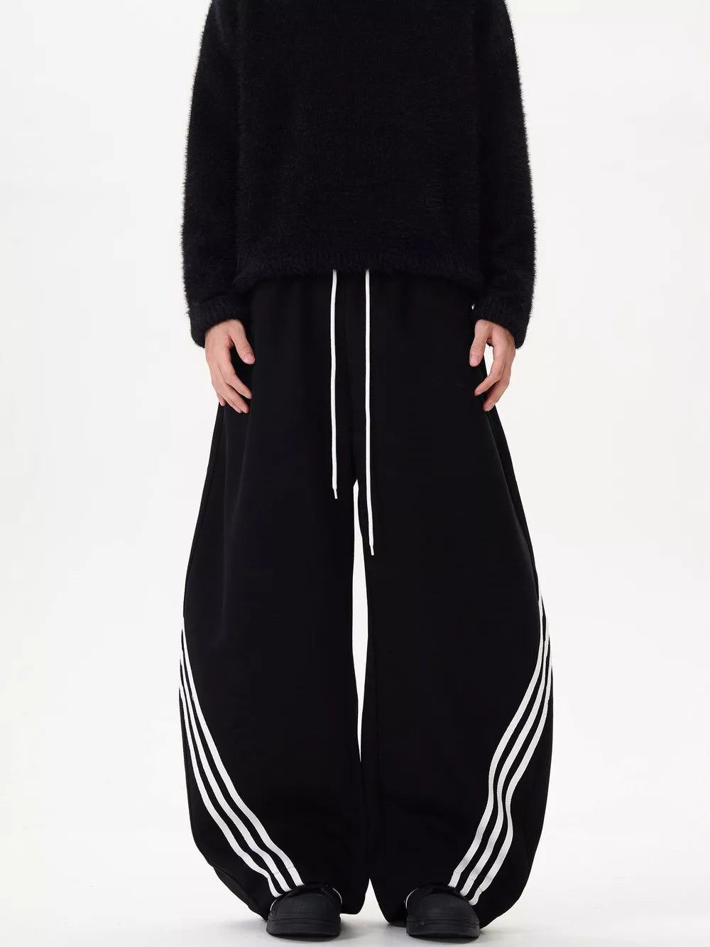 Black wide-leg sweatpants with white drawstring and triple stripe detail