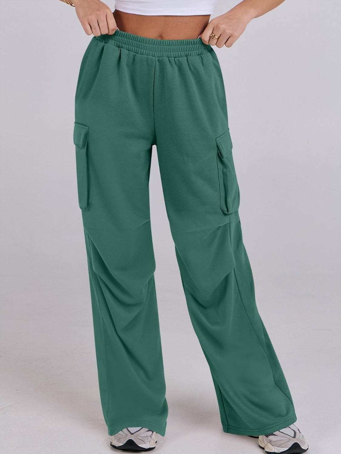Green cargo sweatpants with wide legs and elastic waist.