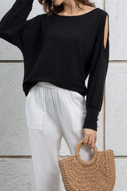 Black shoulder-slit top with button cuff details and a boat neck.