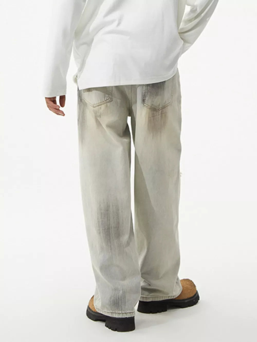 Distressed light wash wide-leg jeans with unique patches and a relaxed fit.