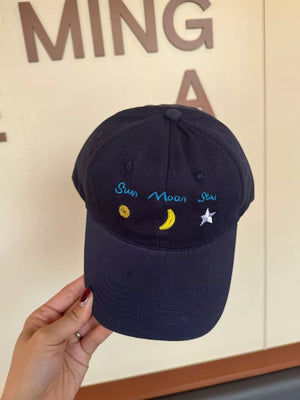 Black cotton baseball cap with embroidered sun, moon, and star details.