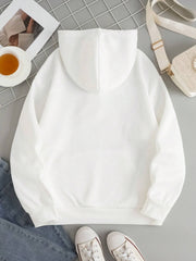 White oversized hoodie with pouch pocket and cuffed sleeves, styled casually.