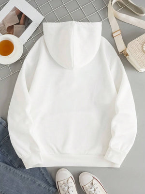 White oversized hoodie with pouch pocket and cuffed sleeves, styled casually.