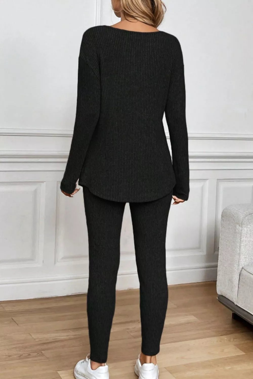 Black ribbed loungewear set with long sleeve top and fitted pants.