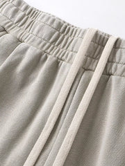 Light gray drawstring wide leg sweatpants with elastic waistband detail.