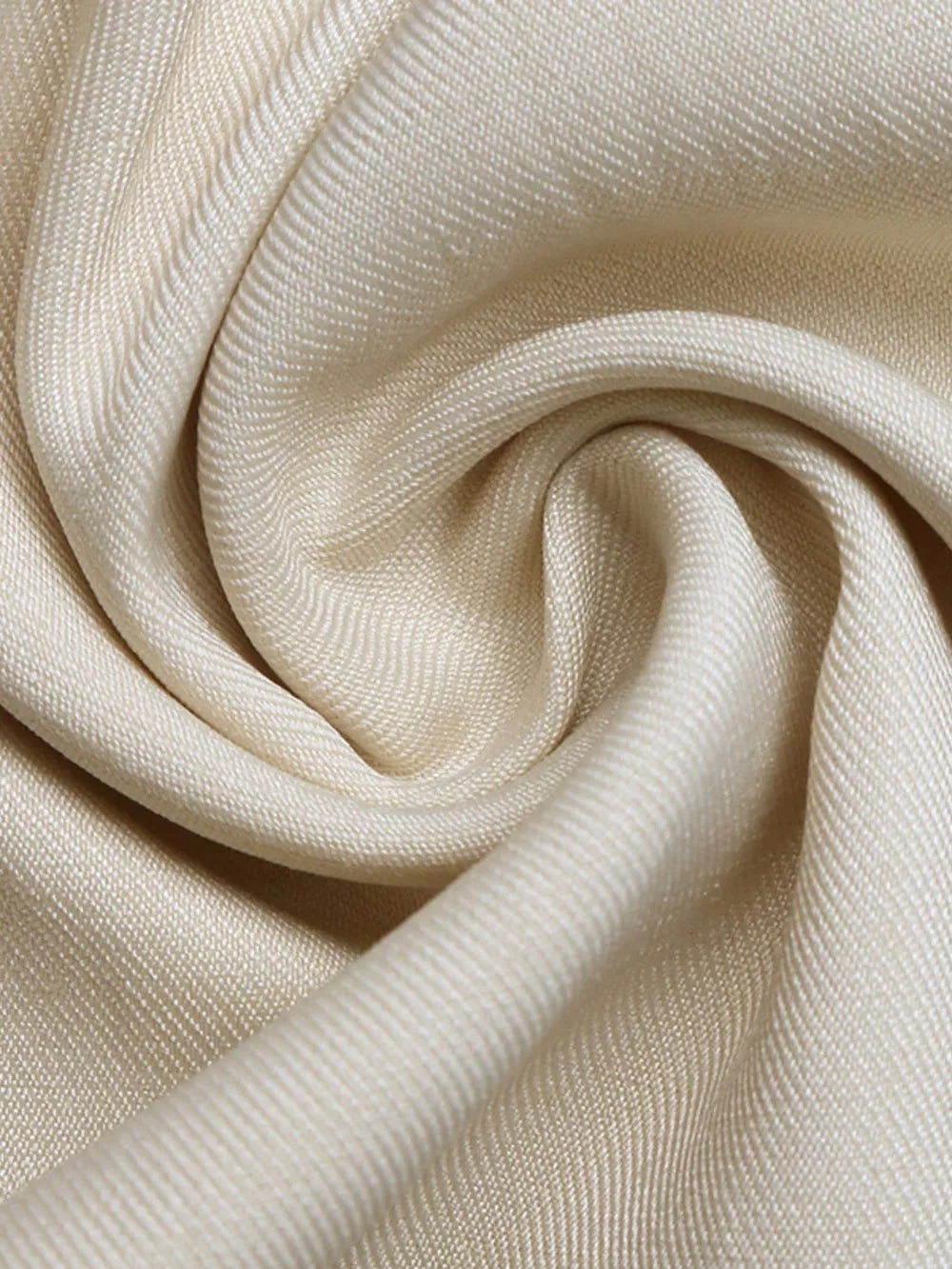 Cream maternity romper fabric detail with subtle texture and drape