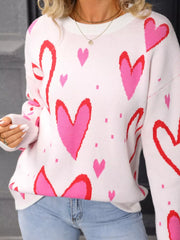 White acrylic crew neck sweater with a pink and red heart pattern