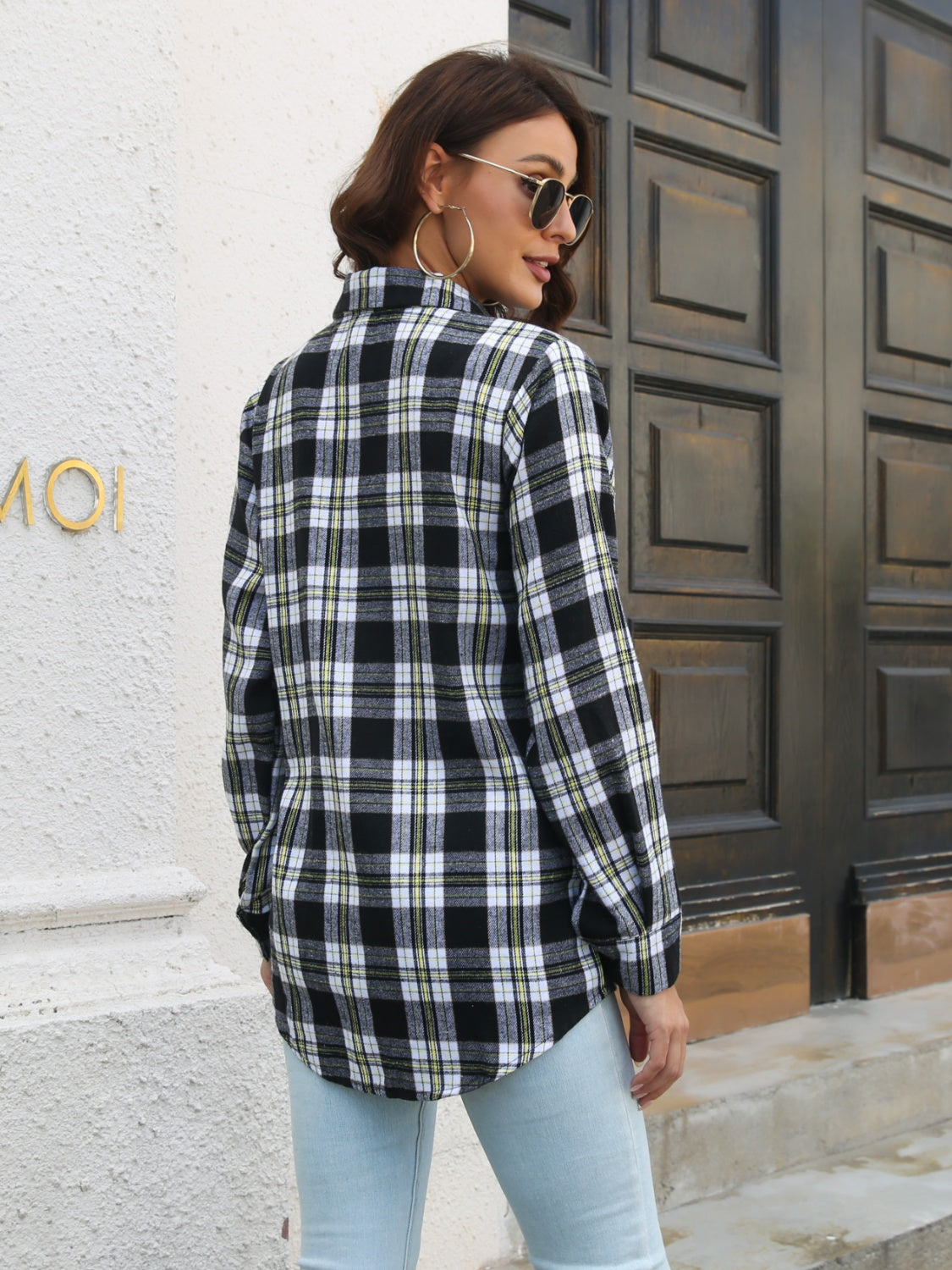 Black plaid overshirt with buttoned cuffs and a curved hem.