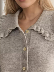 Light Gray knit cardigan with a frilled collar and button front.
