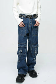 Medium wash denim cargo pants with buckle pockets and straps.