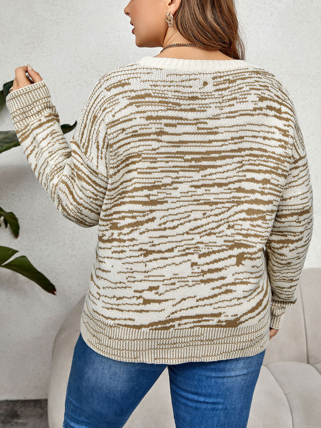 Zebra stripe relaxed fit knit sweater with crew neck and long sleeves.