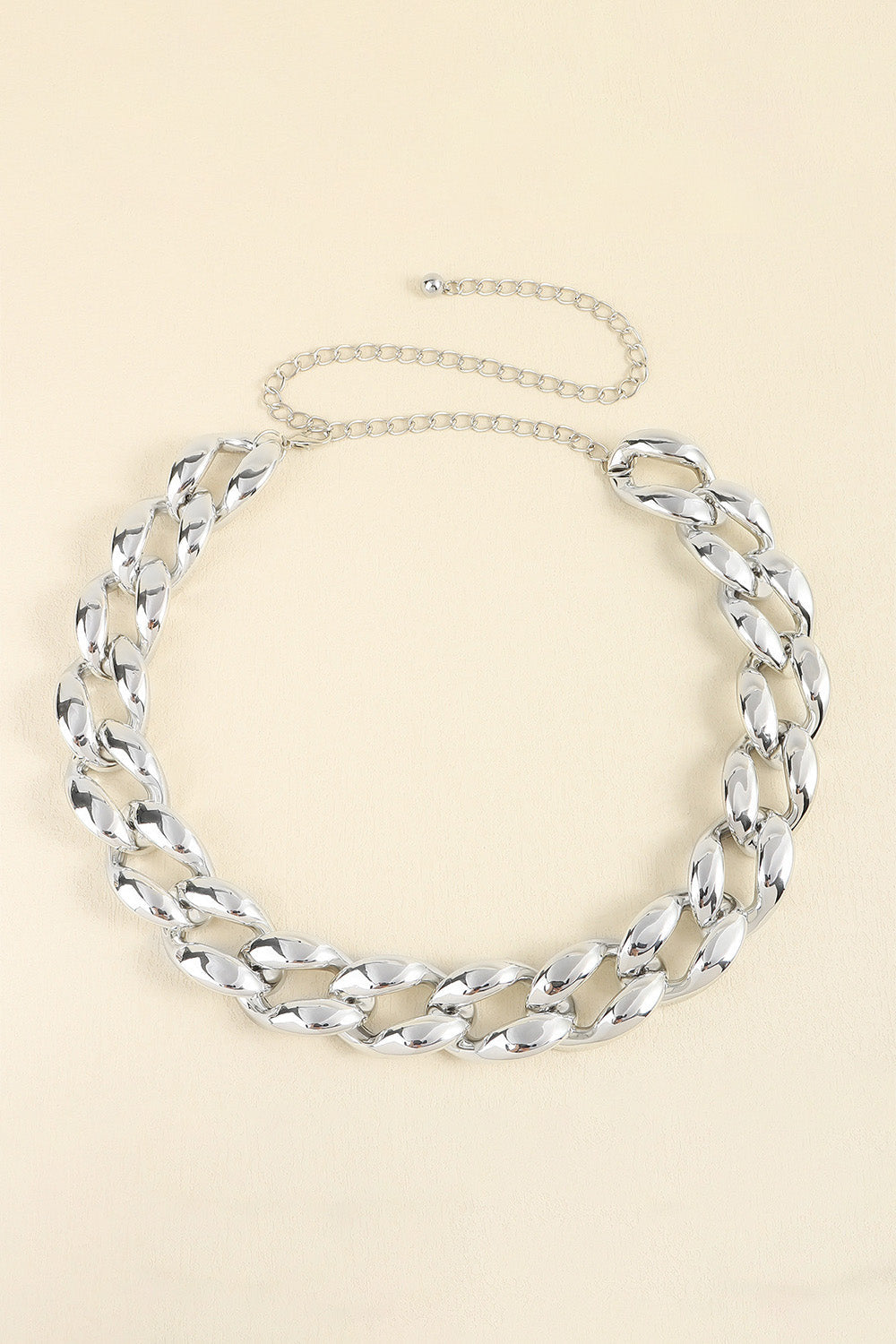 Silver sculptural chain waist belt with adjustable link chain.