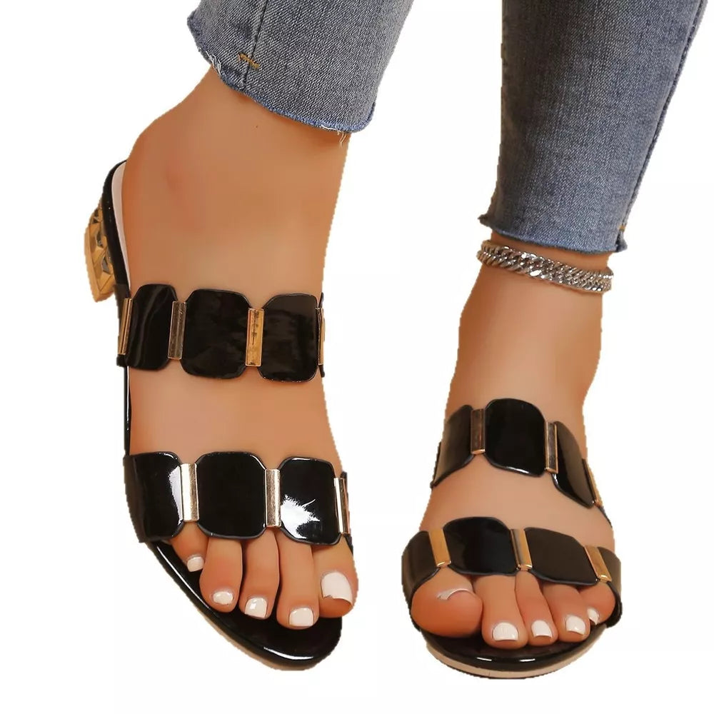 Black block heel sandals with glossy finish and gold accents.
