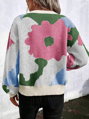 Abstract floral knit sweater with round neck in pink, green, blue, and white.