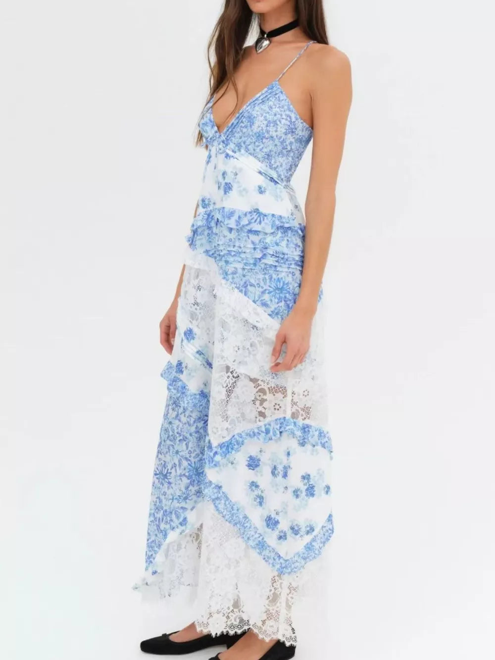 Blue floral lace maxi dress with asymmetrical ruffles and a V-neck.