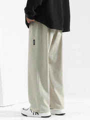 Men's beige casual loose-fit drawstring sweatpants with textured fabric and side pocket detail.