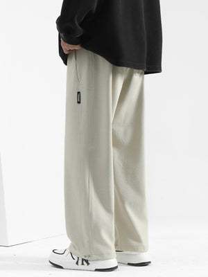 Men's beige casual loose-fit drawstring sweatpants with textured fabric and side pocket detail.