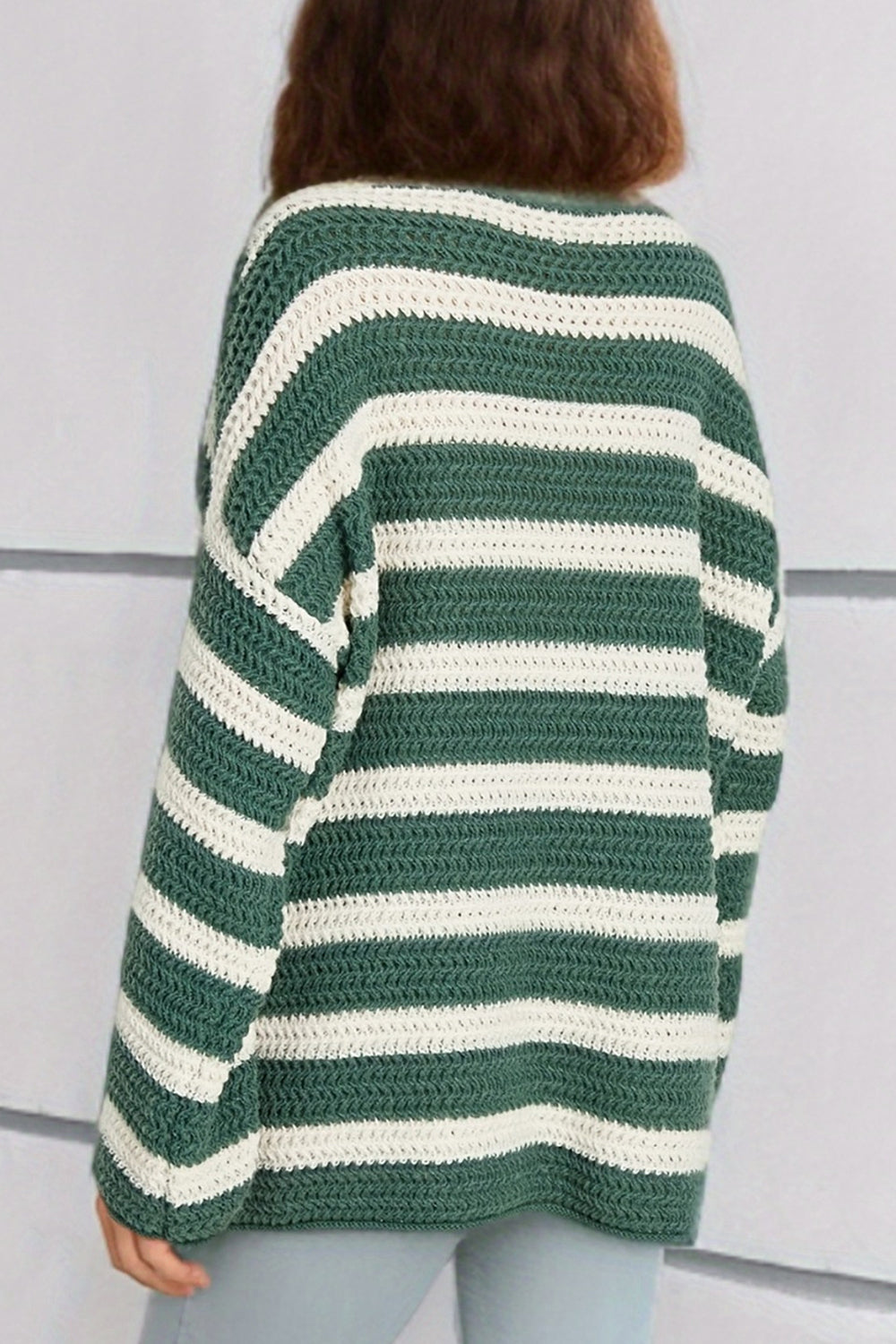 Green and white striped boat neck knit sweater with a textured crochet stitch.