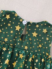 Green tulle baby dress with gold stars and a white button closure.