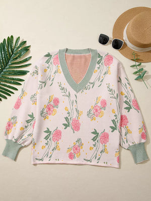 Pink floral v-neck knit sweater with green striped cuffs and neckline detail.