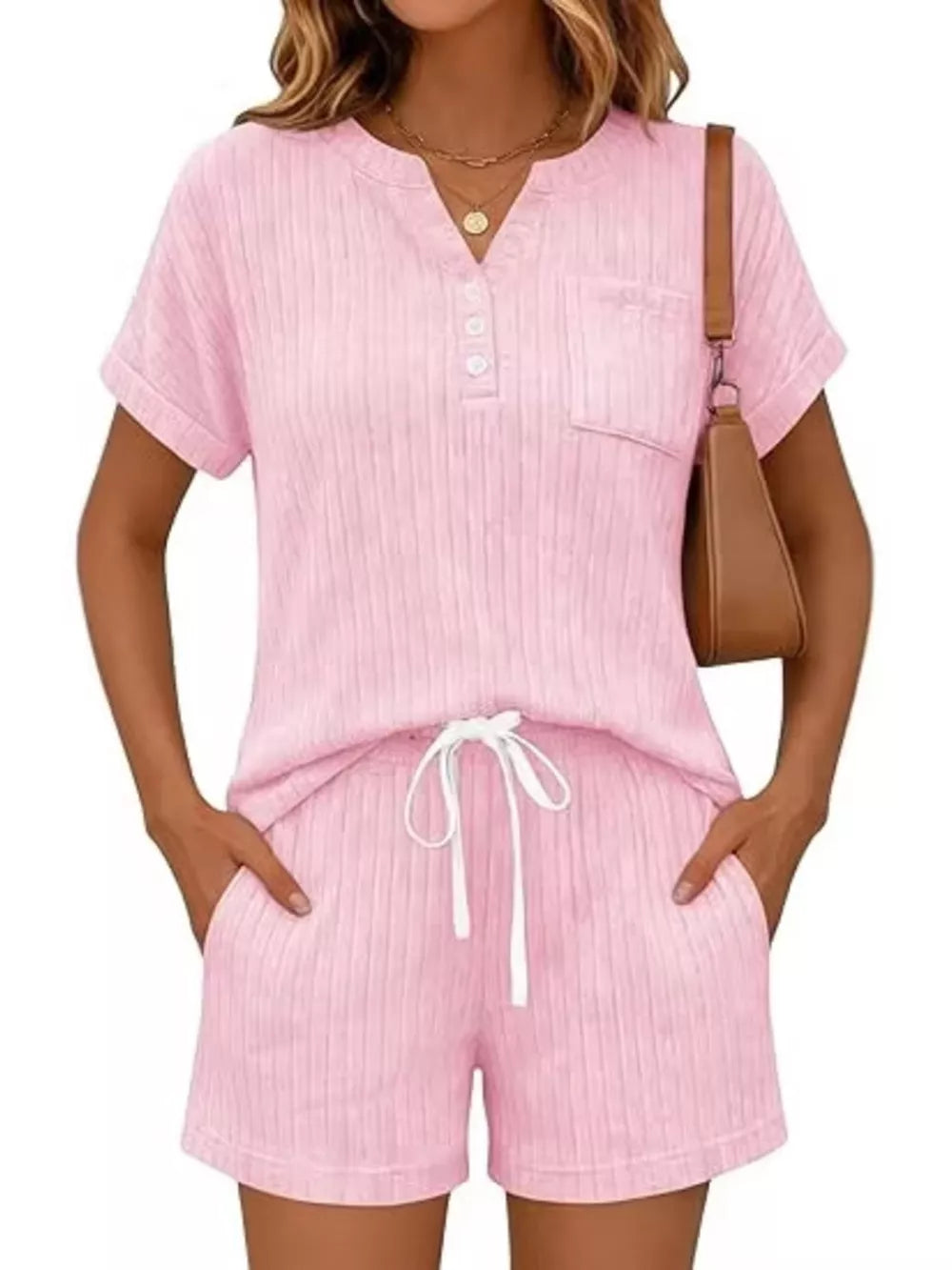 Pink ribbed knit loungewear set with henley neckline, pocket, and drawstring shorts.