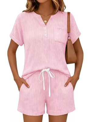Pink ribbed knit loungewear set with henley neckline, pocket, and drawstring shorts.