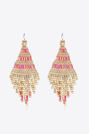 Geometric beaded fringe earrings with gold and pink beads.