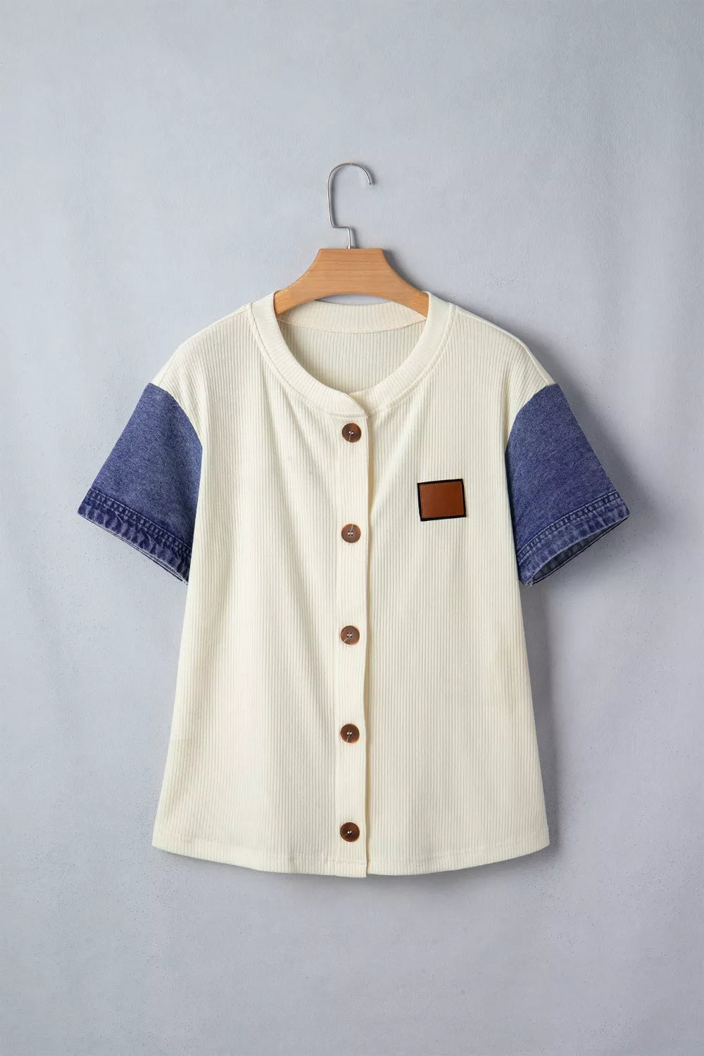 Cream ribbed knit maternity shirt with short denim sleeves, button front, and chest patch.