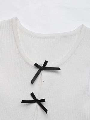 White ribbed knit tank top with black bow details at the neckline