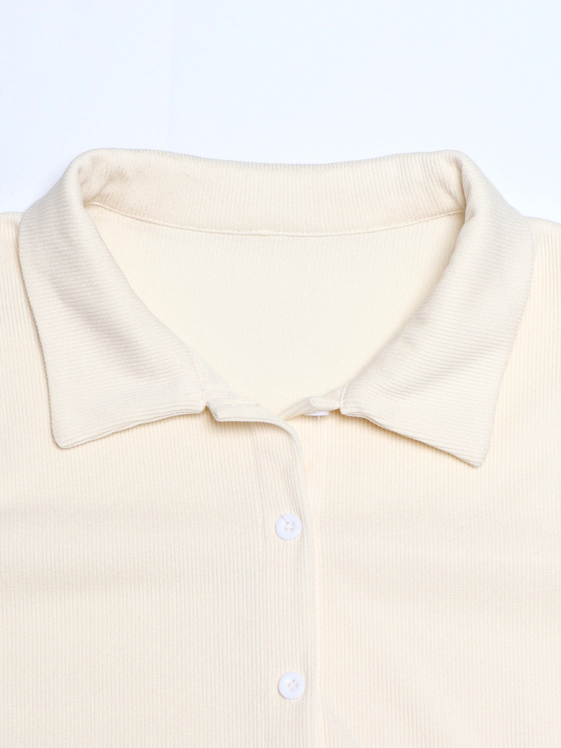 Cream ribbed knit lounge set top with collar and buttons.