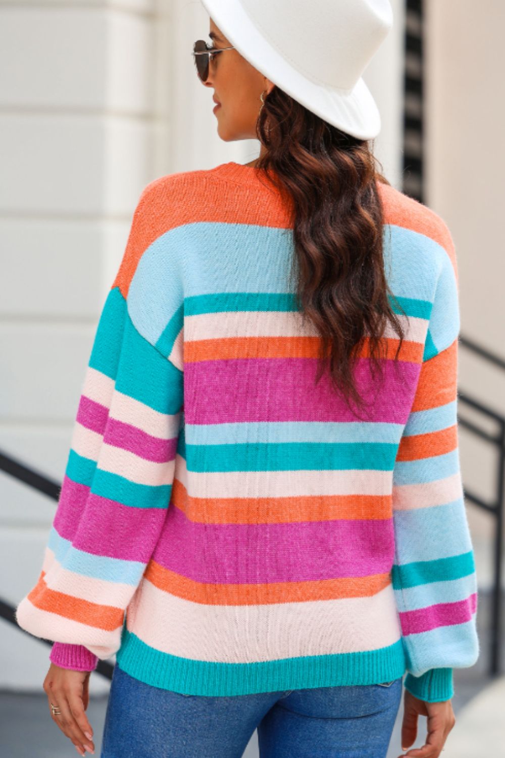 Rainbow stripe knit sweater with balloon sleeves and crew neck.