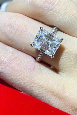 Platinum engagement ring with a large emerald cut diamond and textured band.