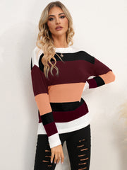 Colorblock crewneck knit sweater with relaxed fit and horizontal stripes in burgundy, peach, black, and white.