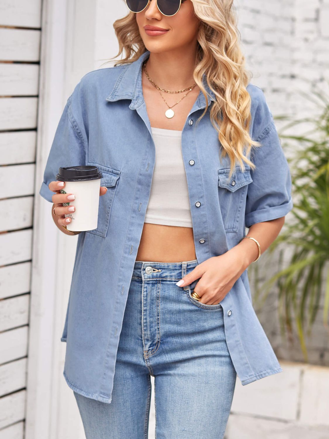 Relaxed light denim shirt jacket with cuffed short sleeves and buttoned chest pockets.