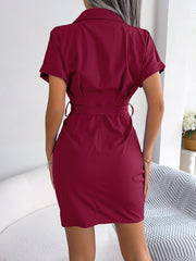Burgundy belted shirt dress with asymmetric ruche detail and short sleeves.